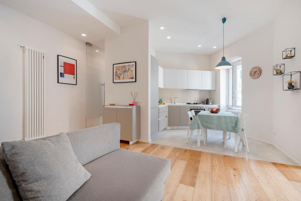 a living room with a couch and a table and a kitchen at Martini Matera 2-luxury apartment in Matera