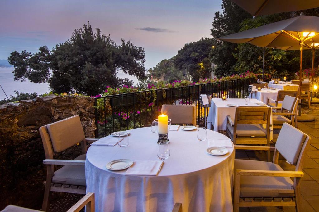 a dining table with a candle on top of it at Hotel Piccolo Portofino in Portofino