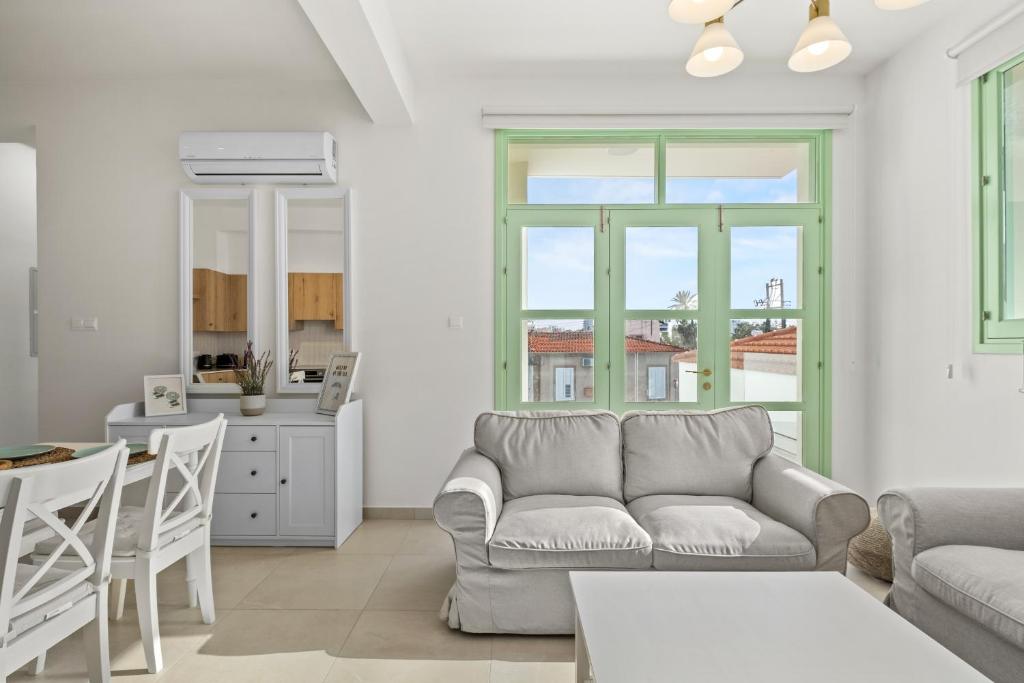 a living room with a couch and a table at Lito - Slow Living in Larnaka