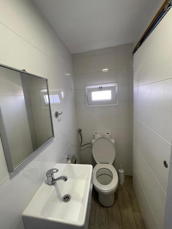 a bathroom with a toilet and a sink and a mirror at Bella Vista House in Eilat