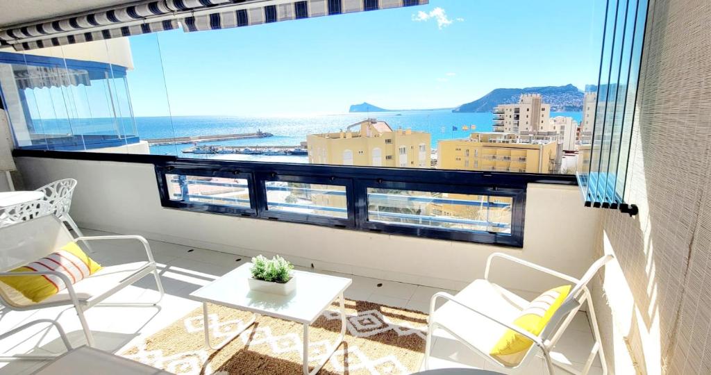 a balcony with a view of the ocean and buildings at Sea View Appartement Blue Monkey in Ifach