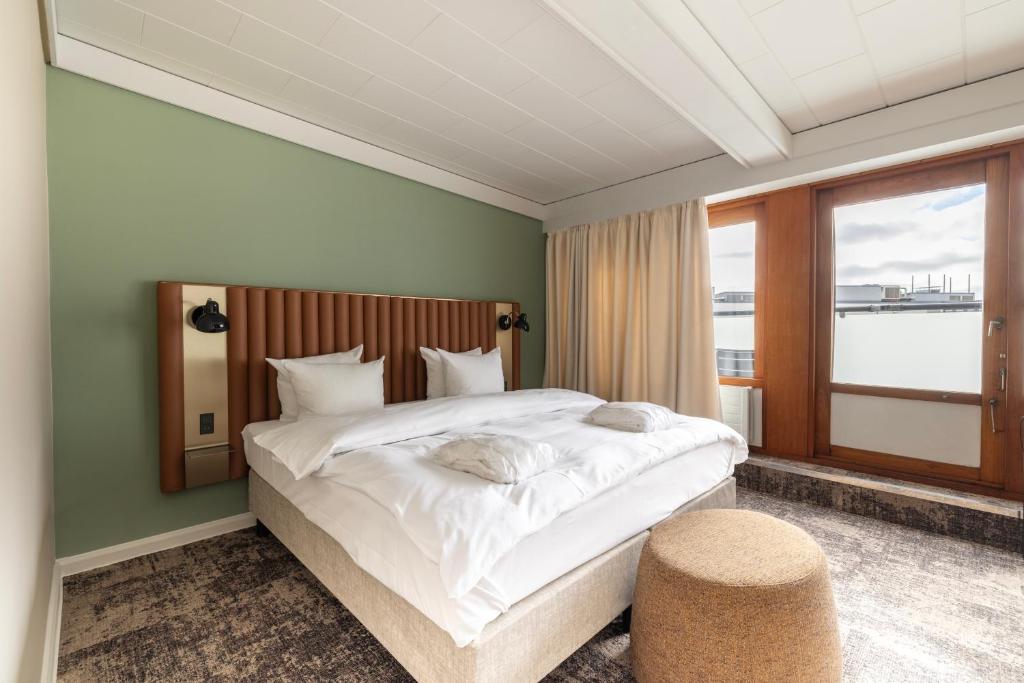 a bedroom with a large white bed and a window at Imperial Hotel in Copenhagen
