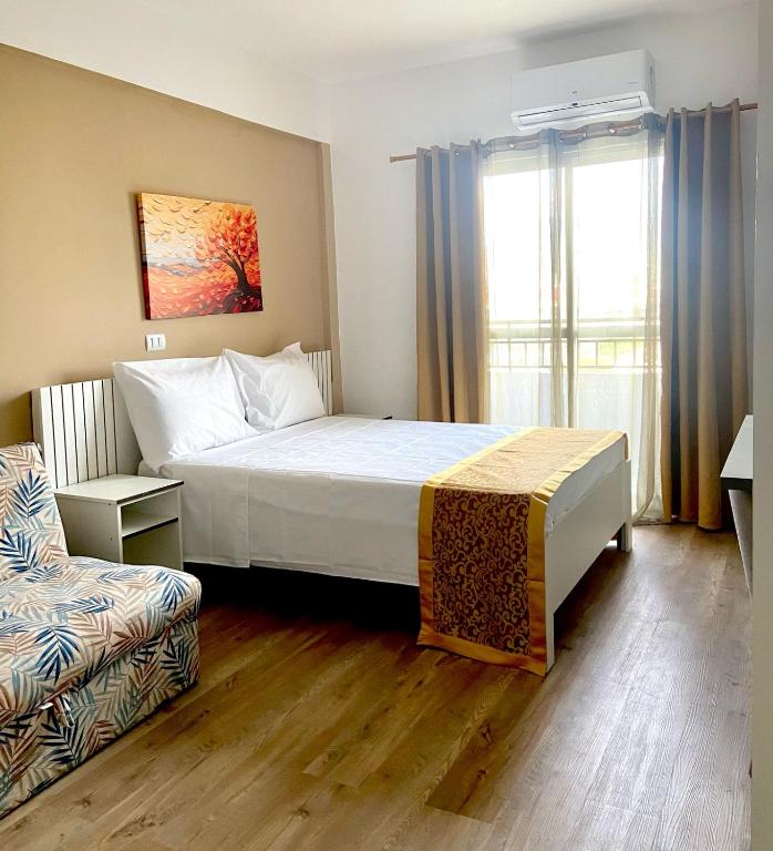 a hotel room with a bed and a couch at Family Residences Brás in São Paulo