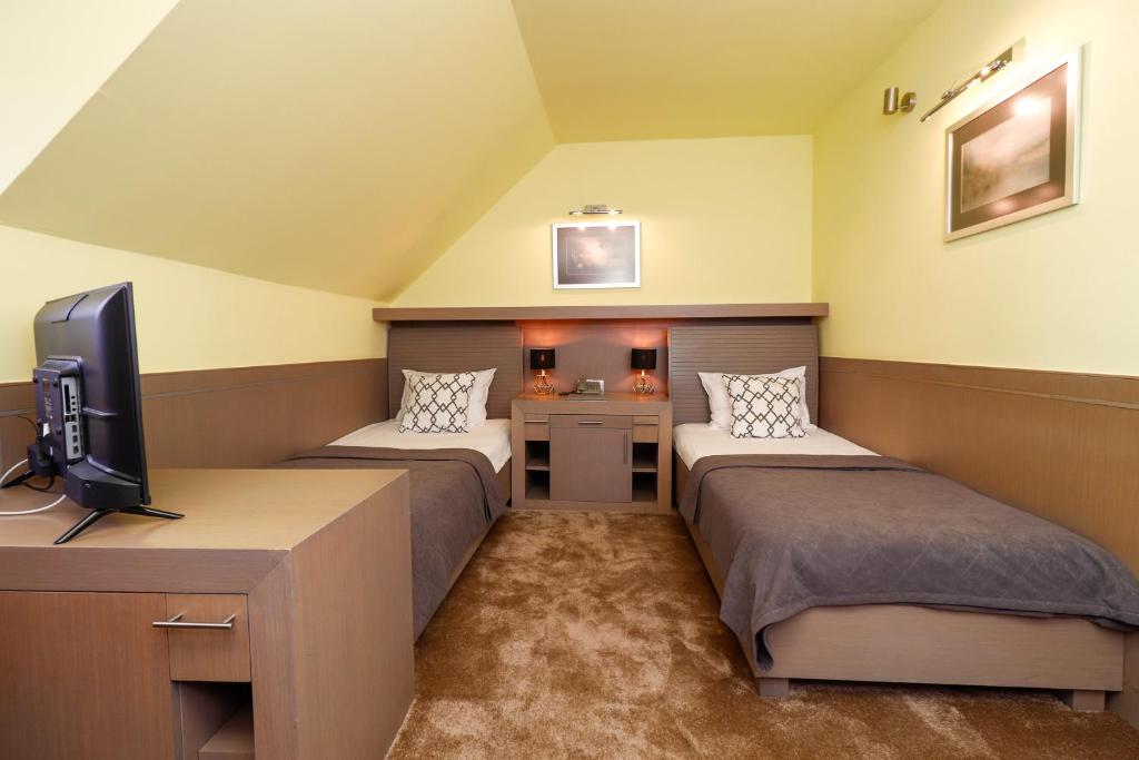 Postel nebo postele na pokoji v ubytování Garni Hotel Leopold I