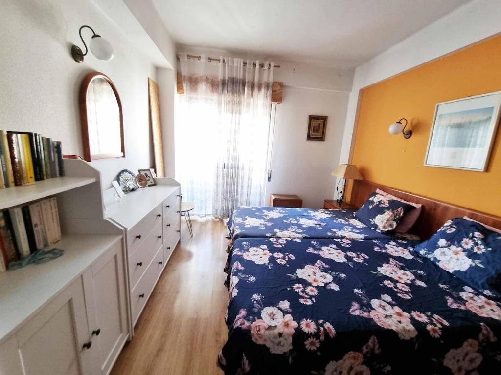 a bedroom with a bed and a dresser and a window at Sun & Fun in Armacao de Pera in Armação de Pêra