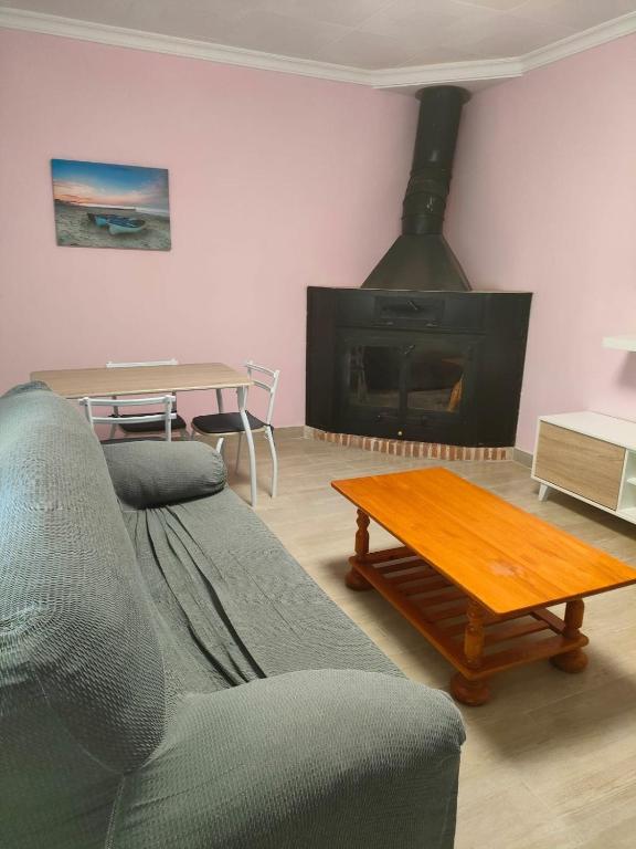 a living room with a couch and a fireplace at Brisas del Lago in Navarrés