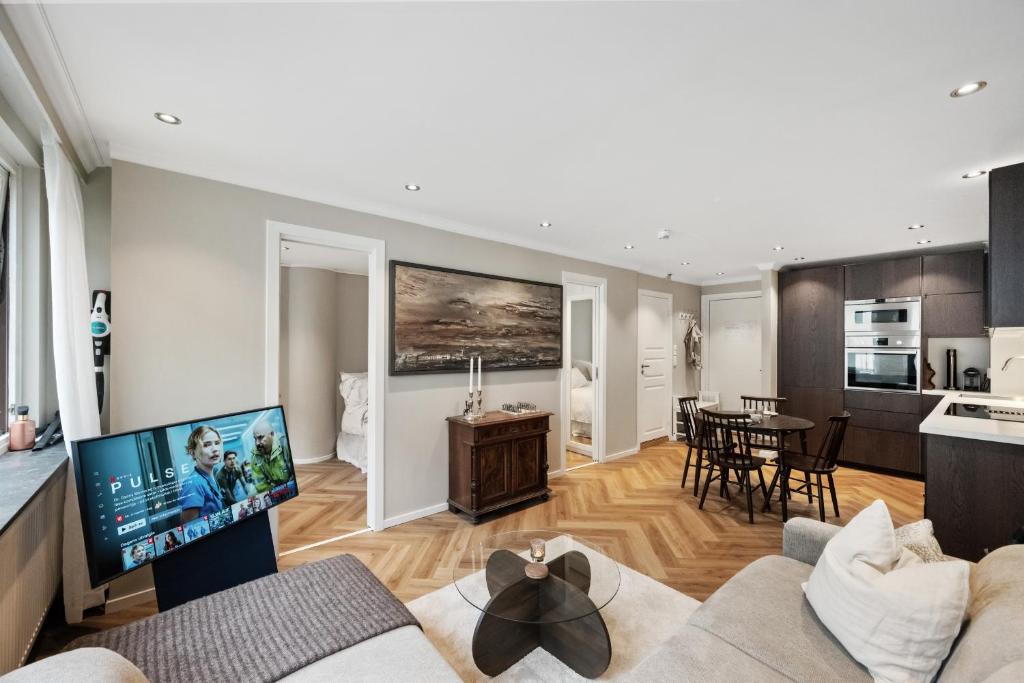 a living room with a couch and a tv at Modern apartment in Bergen city centre in Bergen