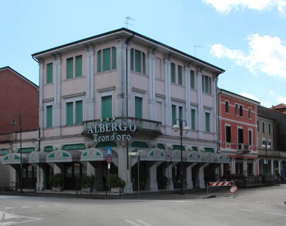 a large white building on a city street at Albergo Ristorante Leon d'Oro in Noventa di Piave