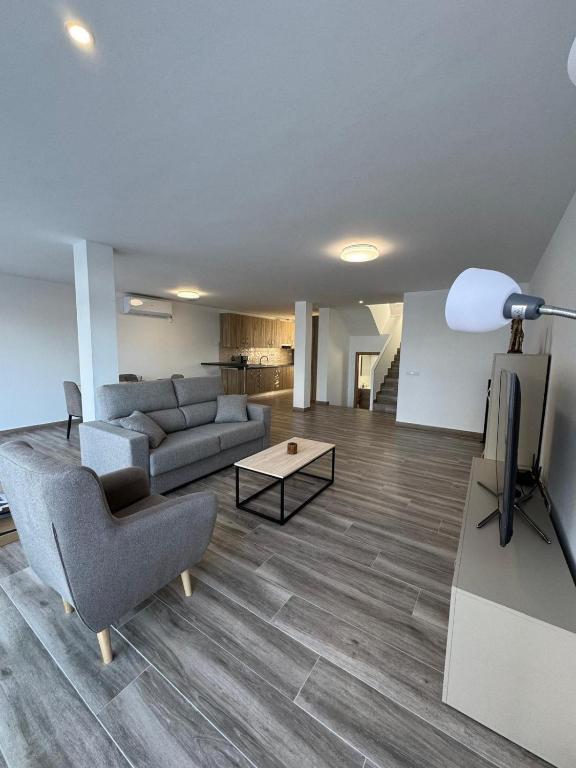 a living room with a couch and a tv at Bungalow Noa in Calpe