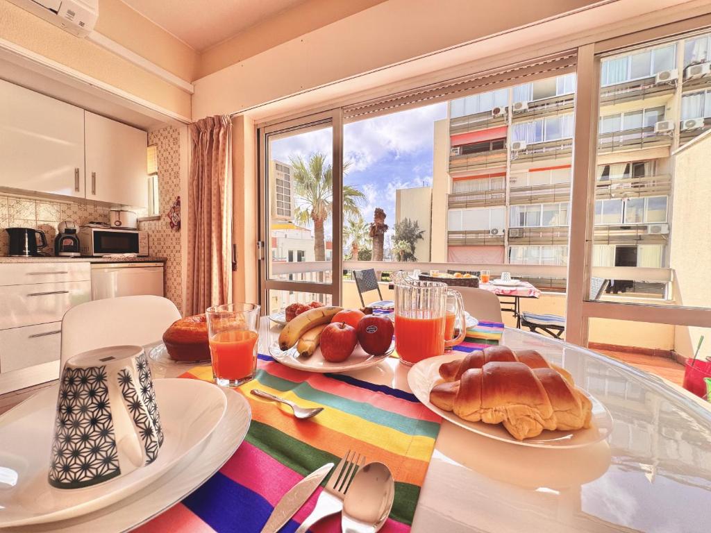 a table with bread and orange juice on it in a kitchen at Vilamoura Central 10 by Homing in Vilamoura