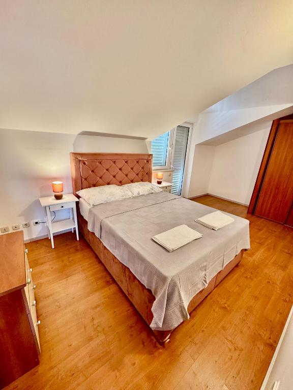 Postel nebo postele na pokoji v ubytování Apartments Dani