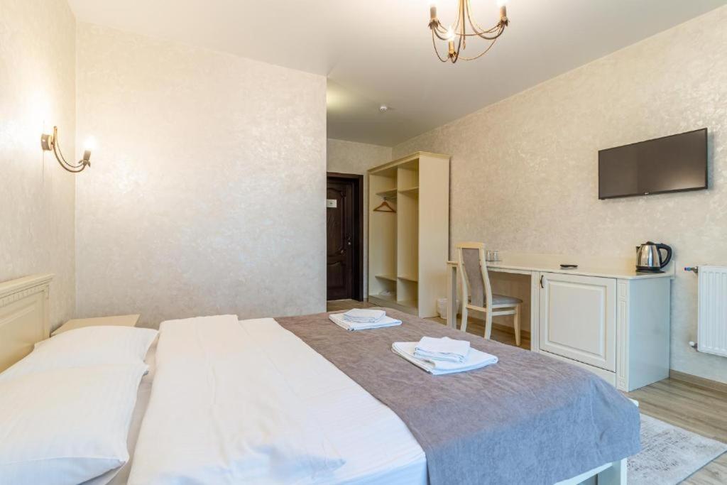Postel nebo postele na pokoji v ubytování Gold Palace SPA Resort Bukovel