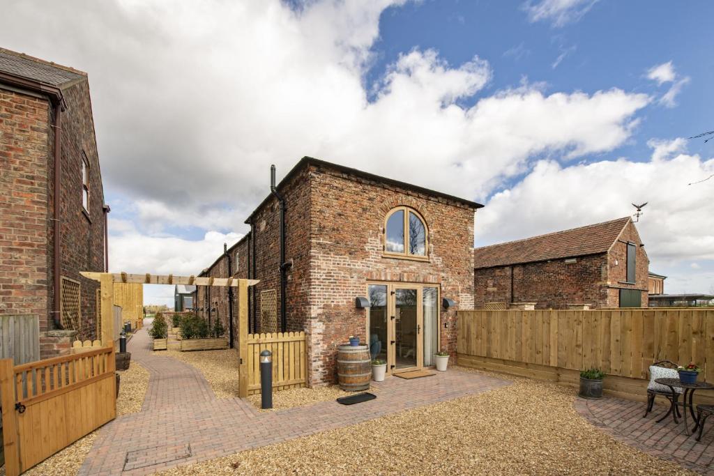 an old brick building with a wooden fence at Bacchus in York