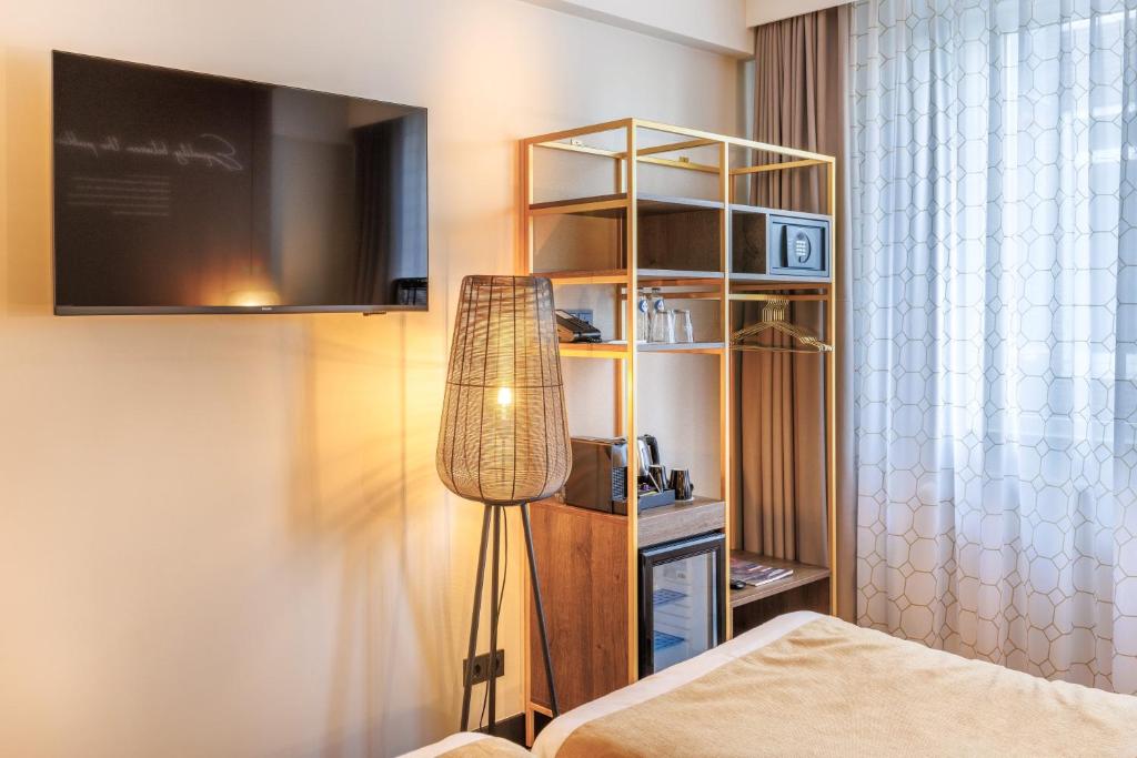Een bed of bedden in een kamer bij Hotel Die Port van Cleve
