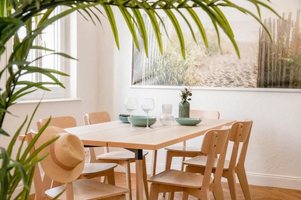 une table à manger, des chaises et une plante dans l'établissement Le Palais Madrid, à Cannes