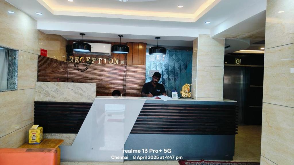 a man standing at the counter of a restaurant at Hotel Starlight Chennai near DLF,L&T,Miot,Tradecenter,Ramachandra medical coll in Chennai