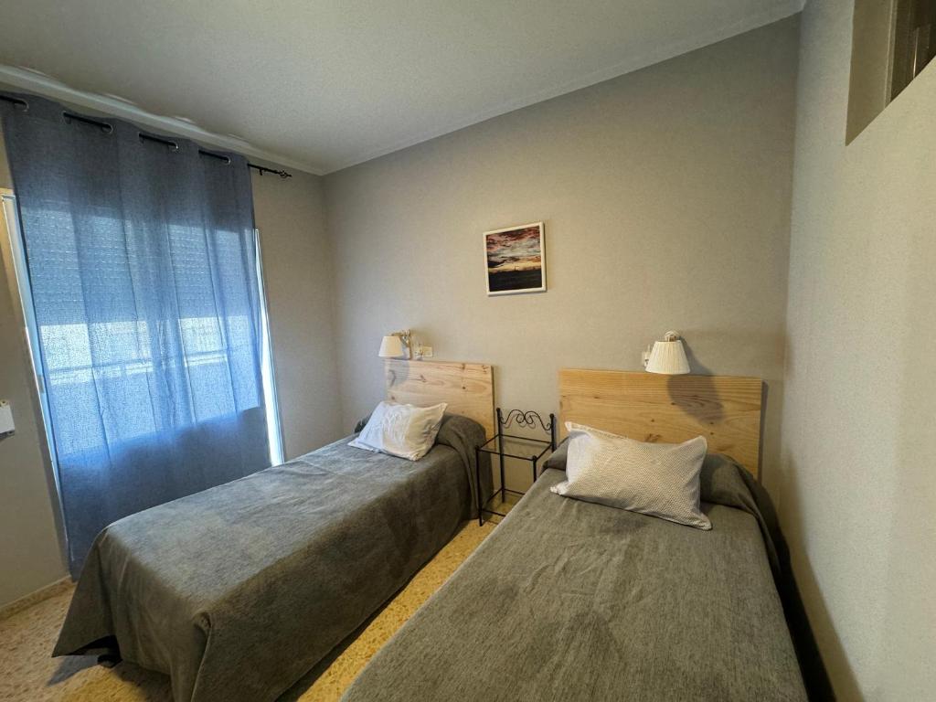 Postel nebo postele na pokoji v ubytování Hostal Miramar