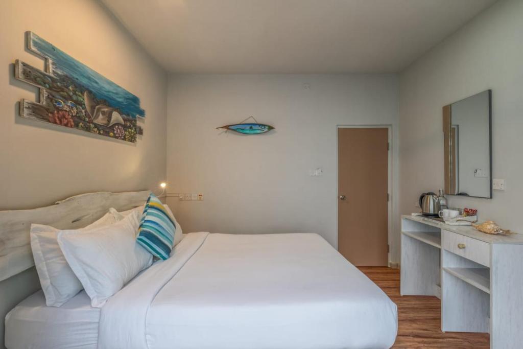 Postel nebo postele na pokoji v ubytování Coquillage Inn