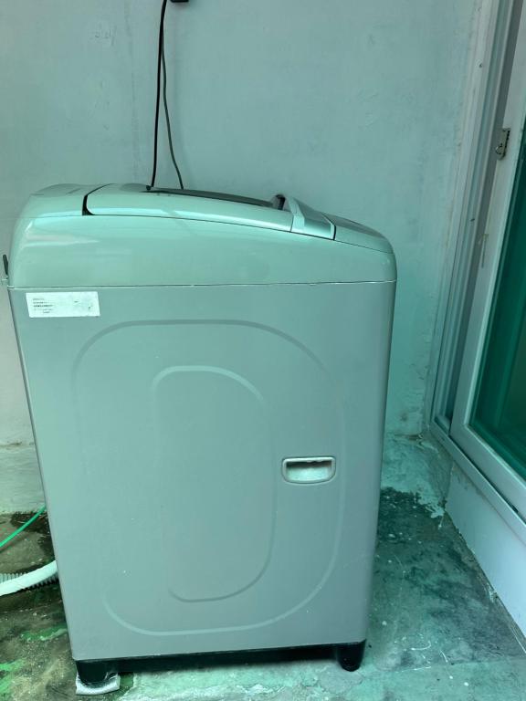 a white refrigerator in a corner of a room at Hanok House with a Yard 1 in Seoul
