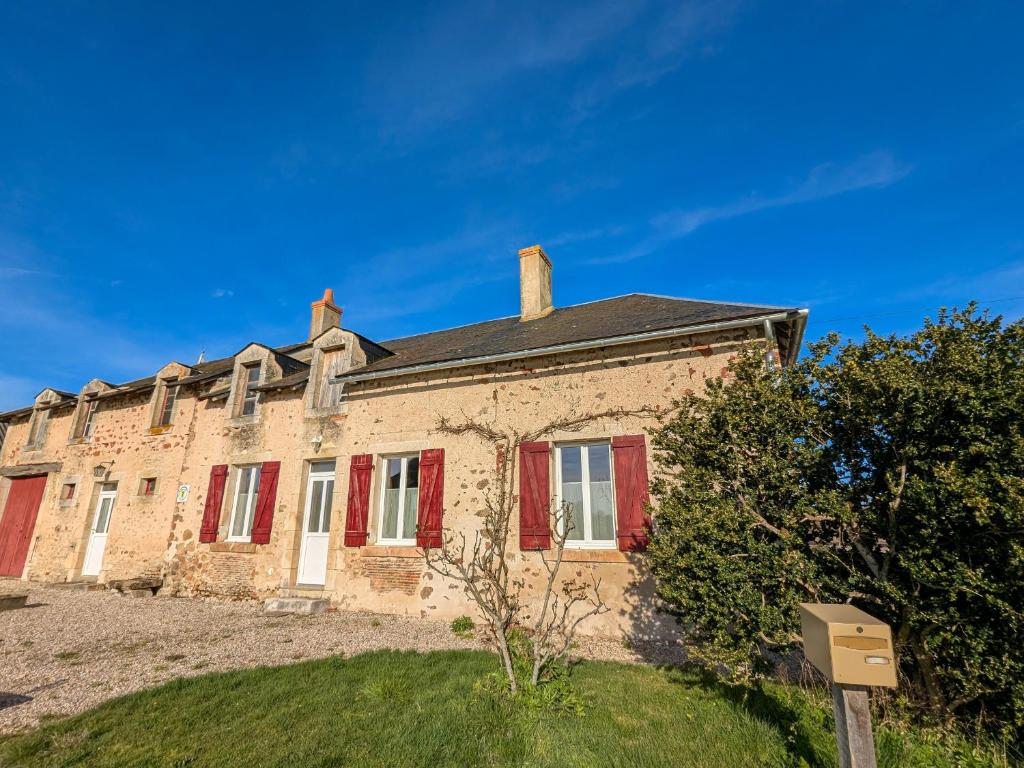 an old brick house with red shutters at Gîte en Brenne avec Terrasse et Garage Privé - FR-1-591-316 in Migné