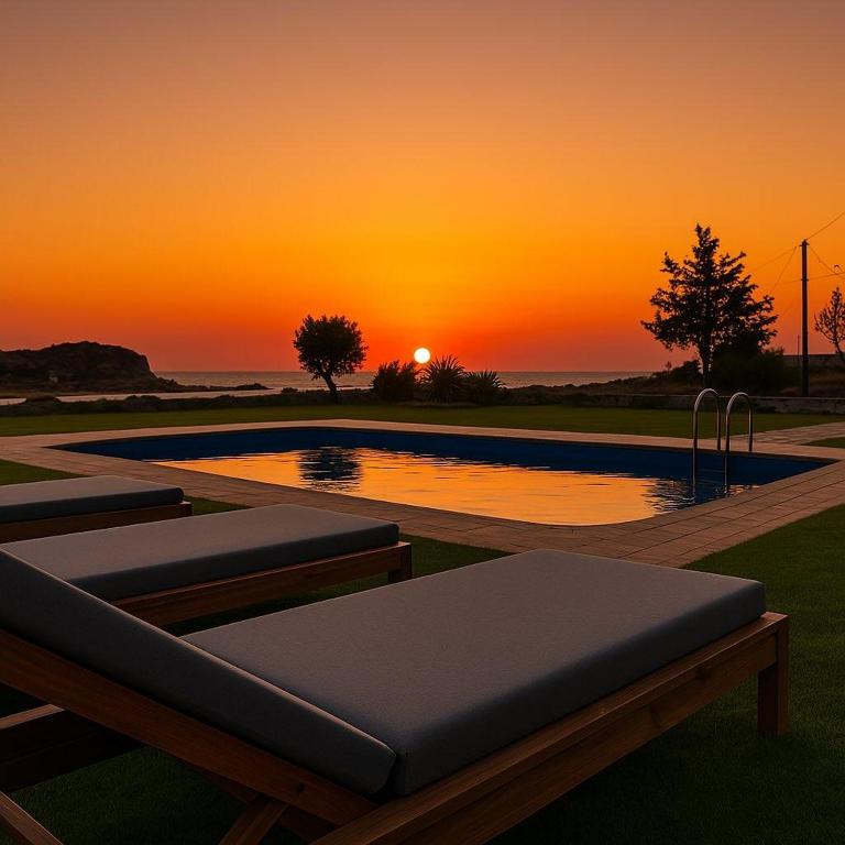 a swimming pool with a sunset in the background at Panorama in Elafonisi