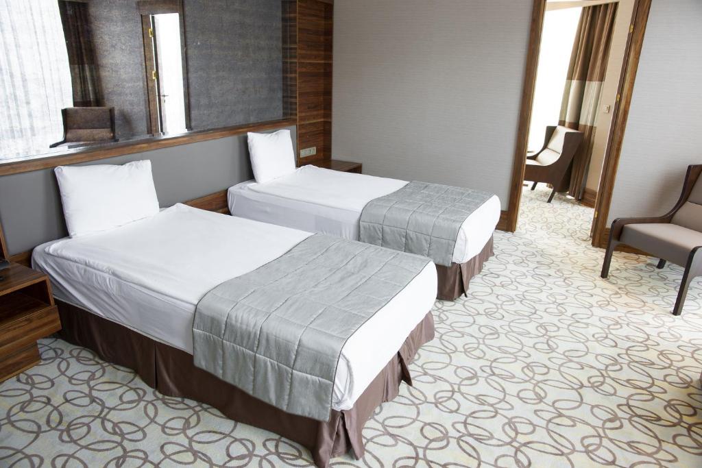 Postel nebo postele na pokoji v ubytování Hotel Palm Emarald