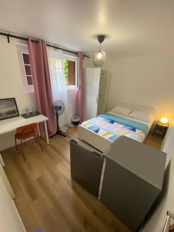 une chambre avec un lit, un bureau et une table dans l'établissement G-Logement-Francilien Goussainville CDG, à Goussainville