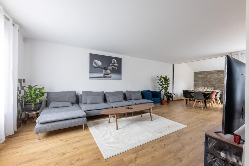 un salon avec un canapé et une table dans l'établissement Beautiful house near Disney for 12 people, à Champs-sur-Marne