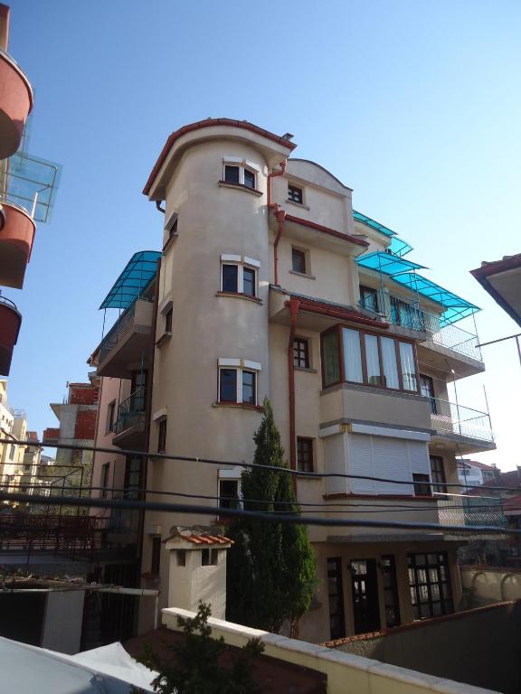 ソゾポルにあるТихия кътの前に木がある背の高い白い建物