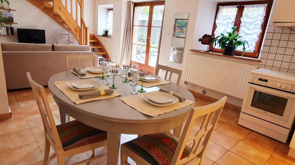 une salle à manger avec une table et des chaises ainsi qu'une cuisine dans l'établissement Chez Maria, à Turckheim