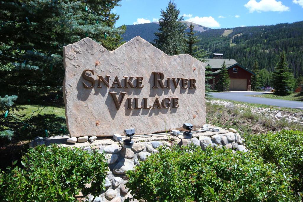 a stone sign for savage river village on a road at Snake River 44 by SummitCove Lodging in Keystone