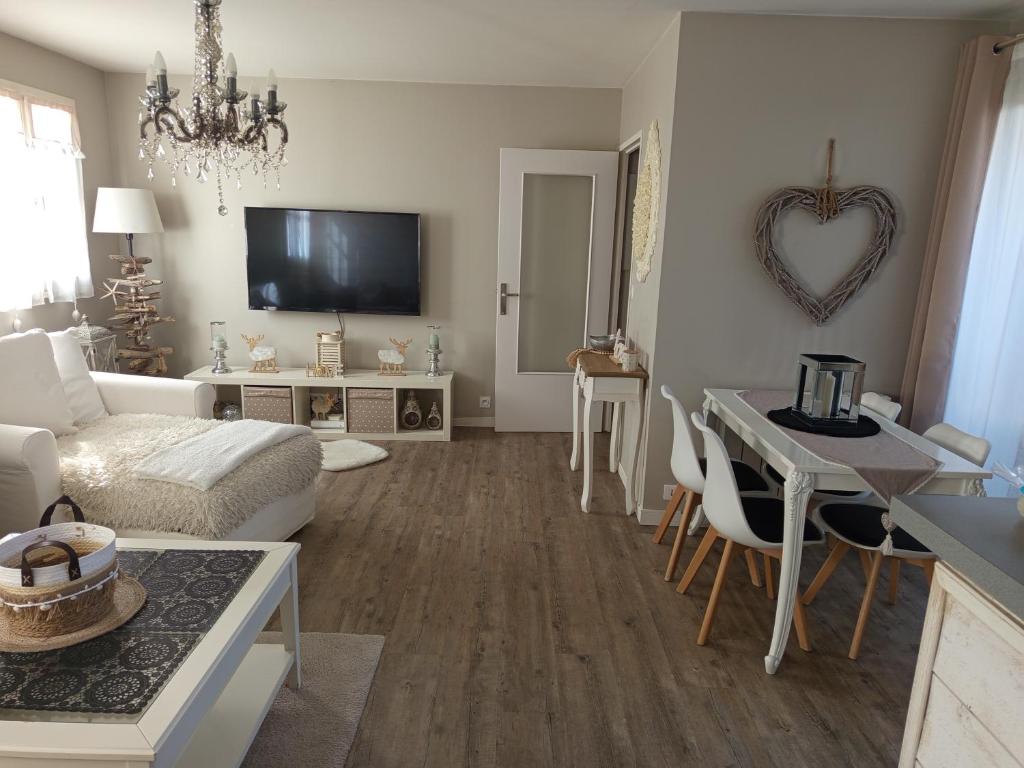 a living room with a couch and a table at Appartement cosy in Le Croisic