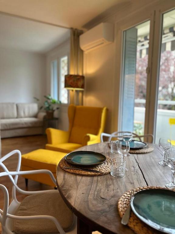 a dining room with a wooden table and chairs at New & Cozy in Lyon