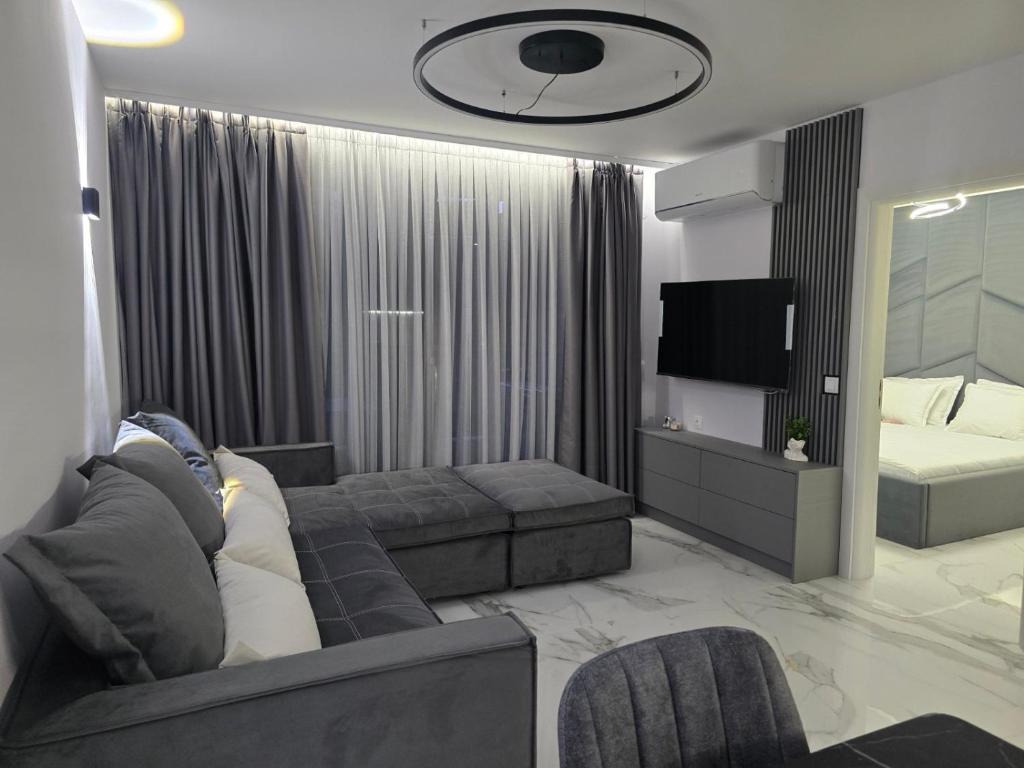 a living room with a couch and a bed at Center Park Apartment in Sandanski