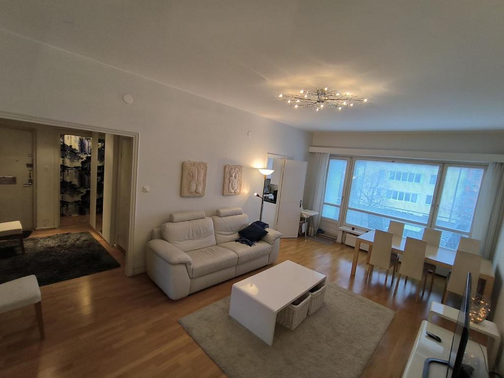 a living room with a couch and a table at Spacious and bright apartment for 4 in Helsinki