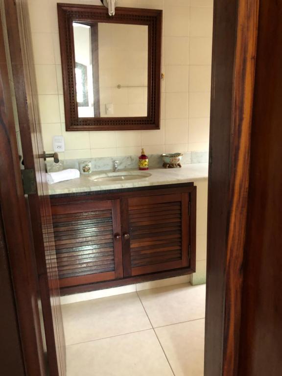 a bathroom with a sink and a mirror at Pousada Sunset Itaúna in Saquarema