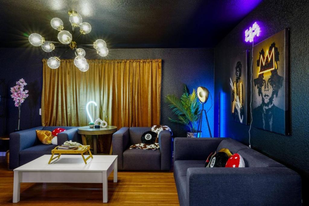 a living room with two blue couches and a table at 5 Bedroom Home 10 Min Drive To Downtown in Denver