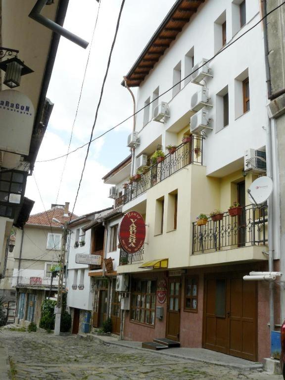 a building with a sign on the side of it at Family Hotel Varusha 2 in Veliko Tŭrnovo