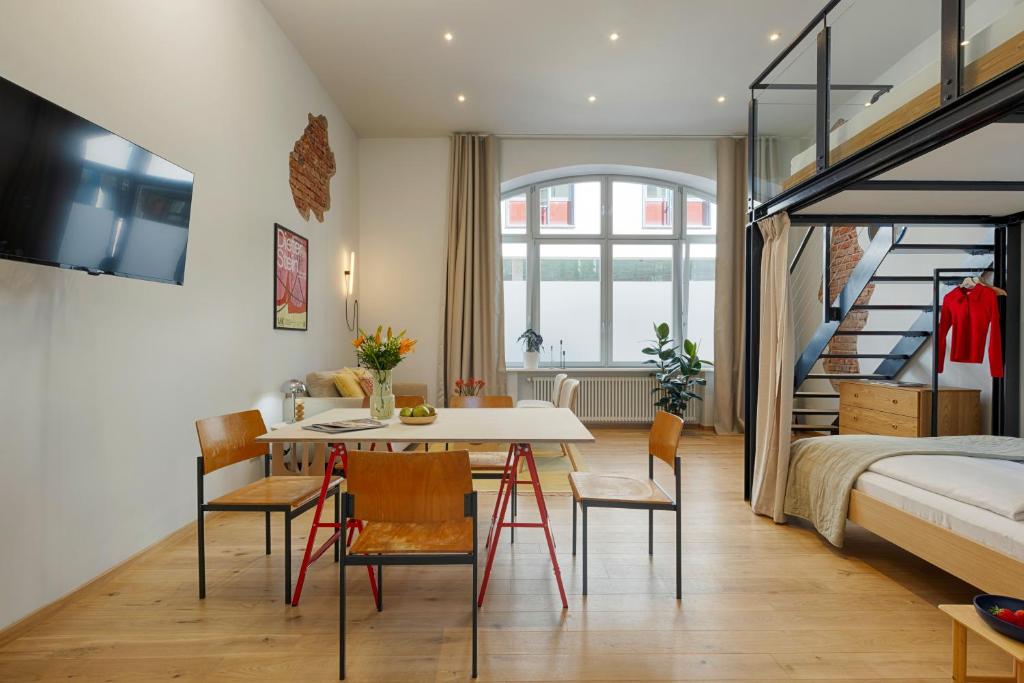 a room with a bed and a table and chairs at homie stay am spital in Würzburg