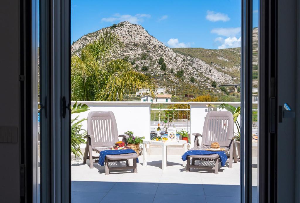 a view of a patio with chairs and a table at Casa Vacanze Giro di Bitta in Siculiana Marina