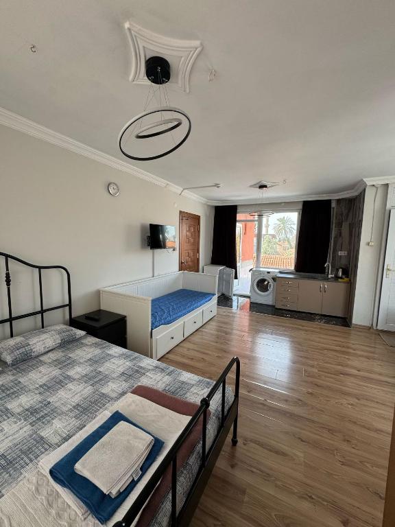 a large room with a bed and a kitchen at Erkal Pension in Antalya