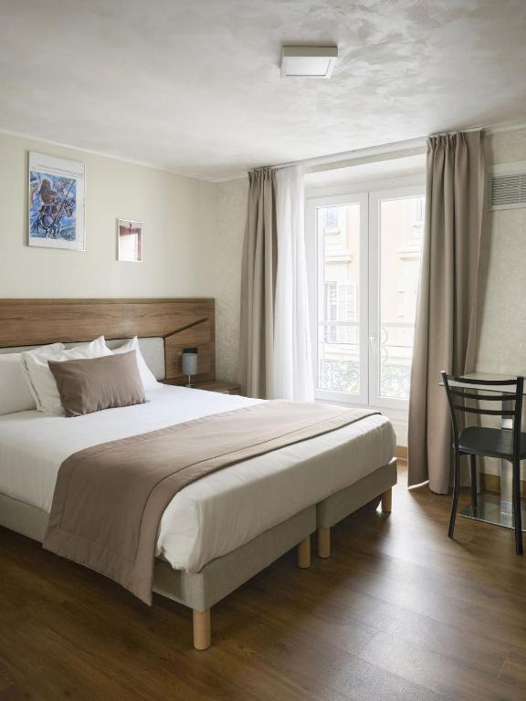 a bedroom with a large bed and a window at Hotel des Congrès et Festivals in Cannes