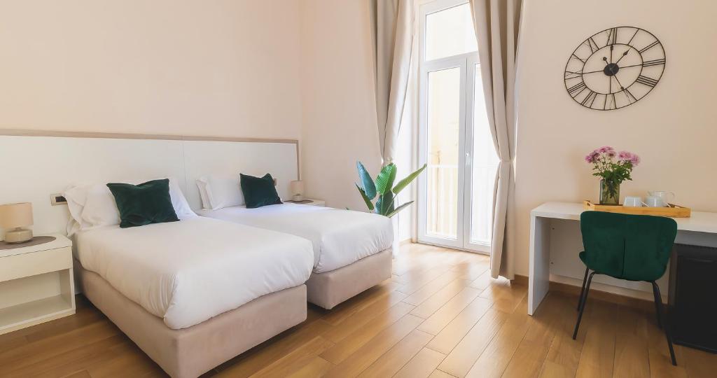 Łóżko lub łóżka w pokoju w obiekcie Musto Suites & Rooms