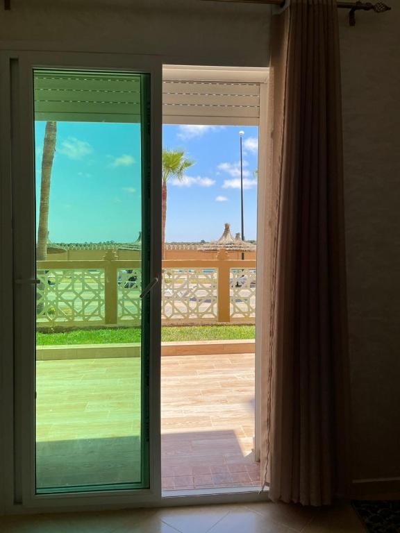 a sliding glass door with a view of a patio at Kawtar in Pont Blondin