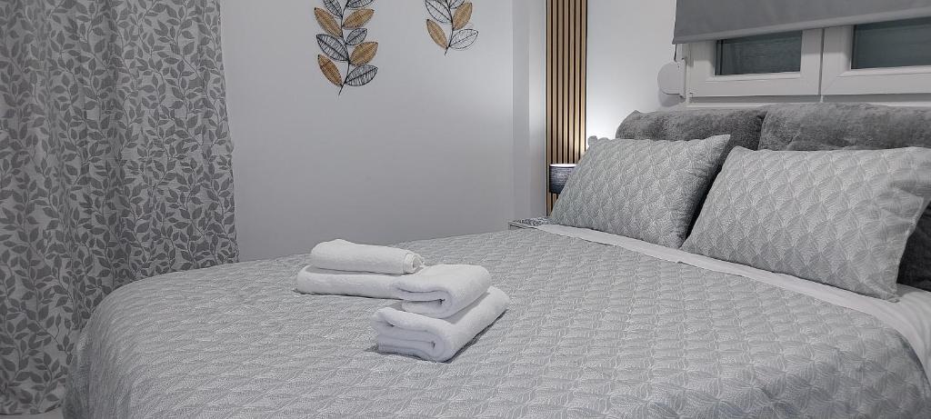 a bedroom with a bed with towels on it at ThessVibe Home in Thessaloniki