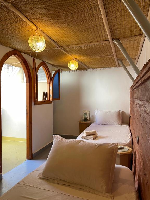 Postel nebo postele na pokoji v ubytování Riad Numidia