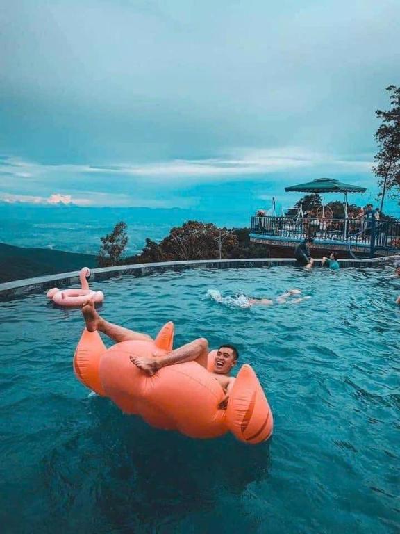 a person in an inflatable raft in the water at Mimosa 228-phòng săn mây in Tam Ðảo