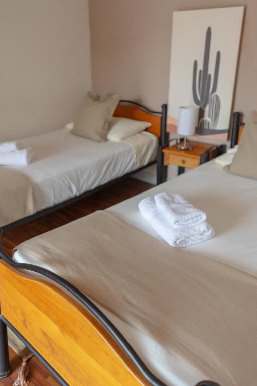 Postel nebo postele na pokoji v ubytování Hostal Katarpe
