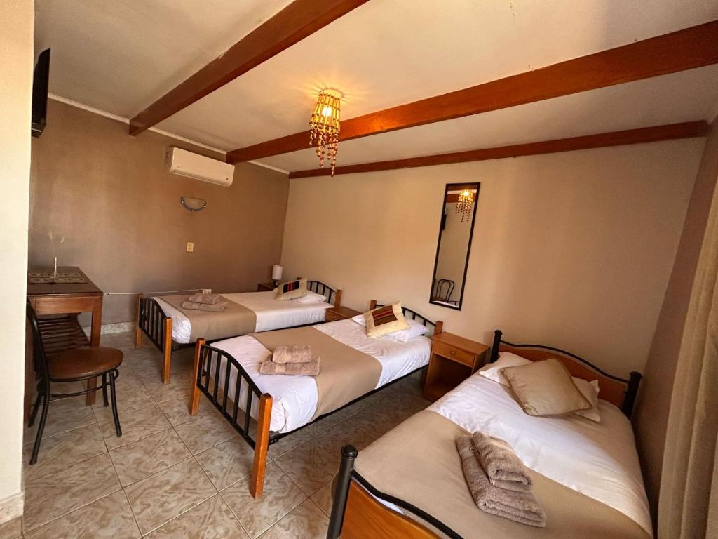 Postel nebo postele na pokoji v ubytování Hostal Katarpe