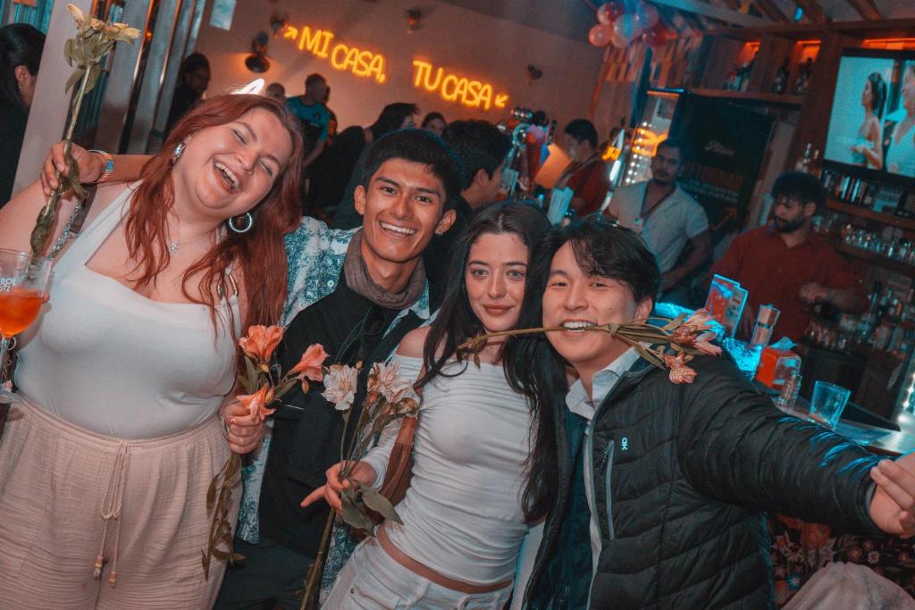 a group of people posing for a picture in a bar at Viajero Cusco Hostel in Cusco
